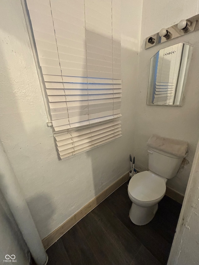 bathroom featuring hardwood / wood-style floors and toilet