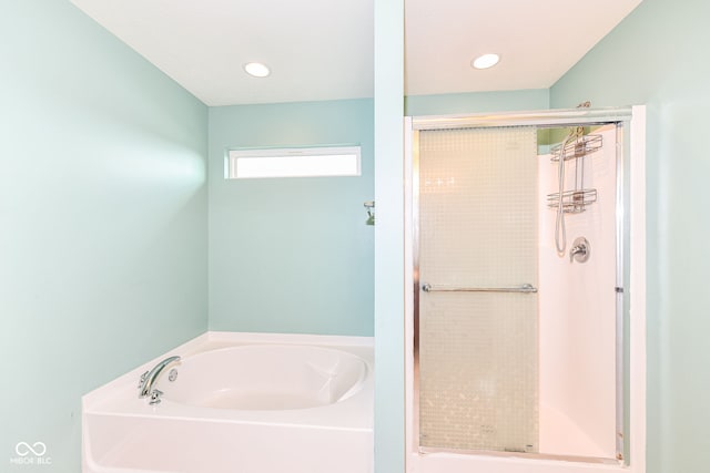 bathroom with shower with separate bathtub