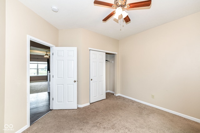 unfurnished bedroom featuring ceiling fan, carpet floors, and a closet