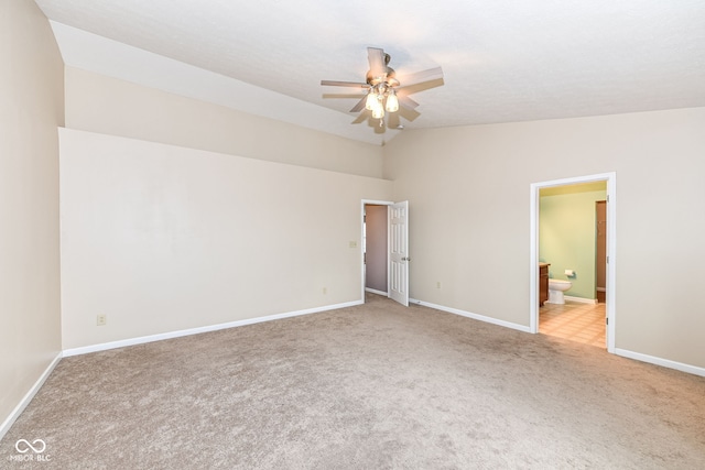 carpeted empty room with ceiling fan and lofted ceiling