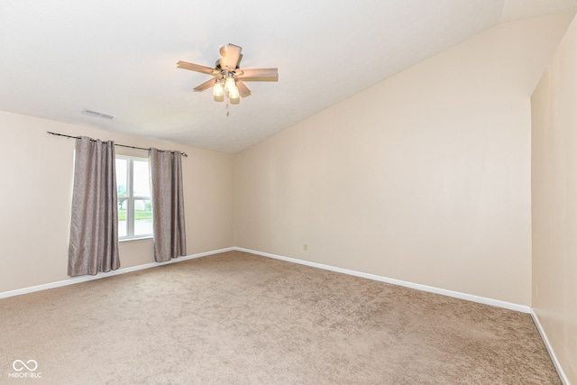 carpeted empty room featuring ceiling fan and lofted ceiling