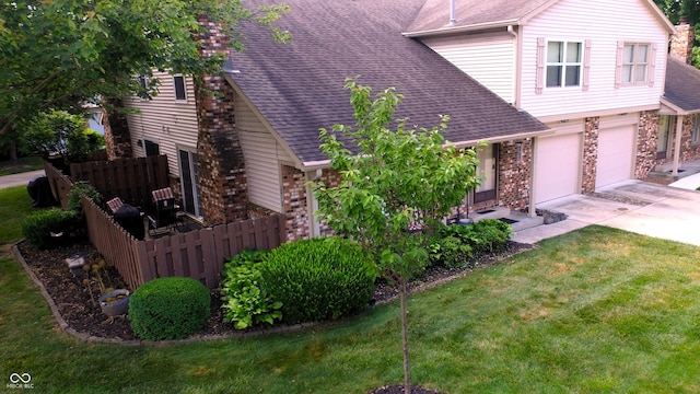 view of side of home featuring a yard and a garage