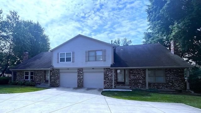 front of property with a front yard and a garage