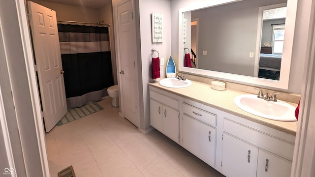 bathroom with tile patterned flooring, a shower with curtain, vanity, and toilet