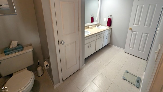 bathroom featuring tile patterned floors, vanity, and toilet