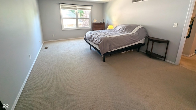 bedroom featuring light carpet