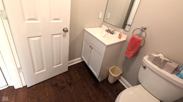 bathroom featuring hardwood / wood-style flooring, vanity, and toilet