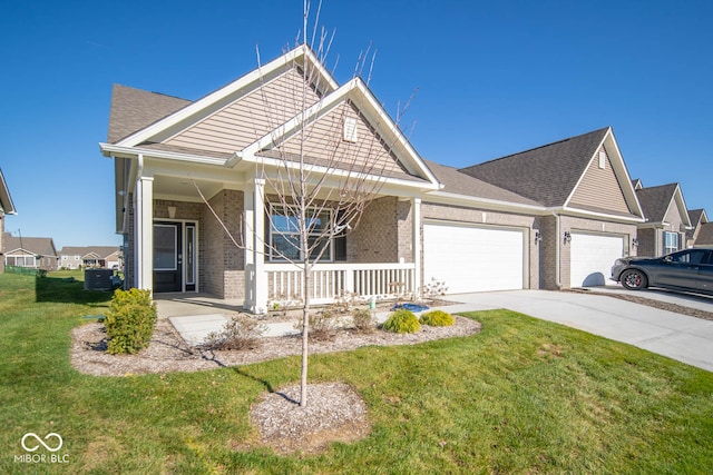 view of front of house featuring a porch, a garage, a front yard, and central AC