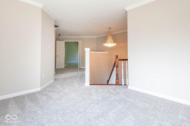 carpeted empty room featuring a textured ceiling and crown molding