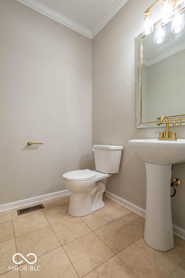 bathroom featuring toilet, tile patterned flooring, and crown molding