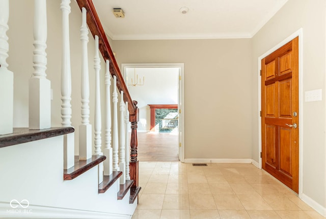 tiled entrance foyer with crown molding