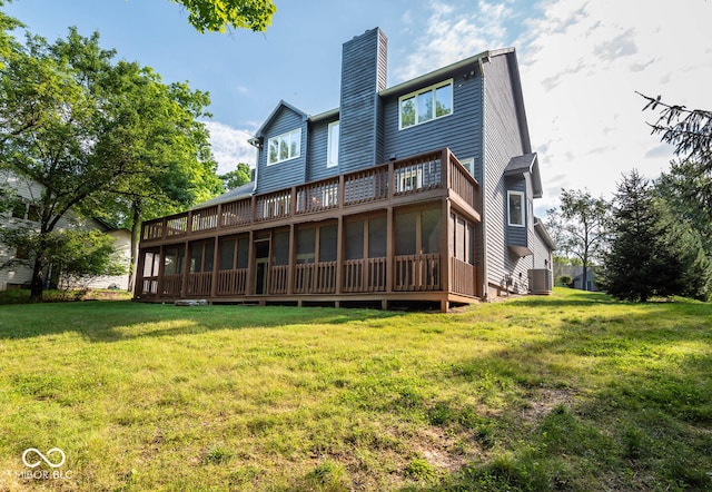 back of property featuring a yard, central air condition unit, and a sunroom