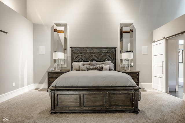 bedroom featuring carpet flooring and a barn door