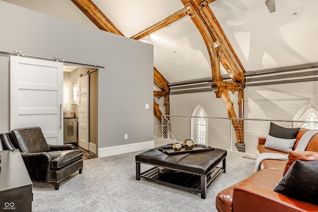 carpeted living room with a barn door, beam ceiling, and high vaulted ceiling