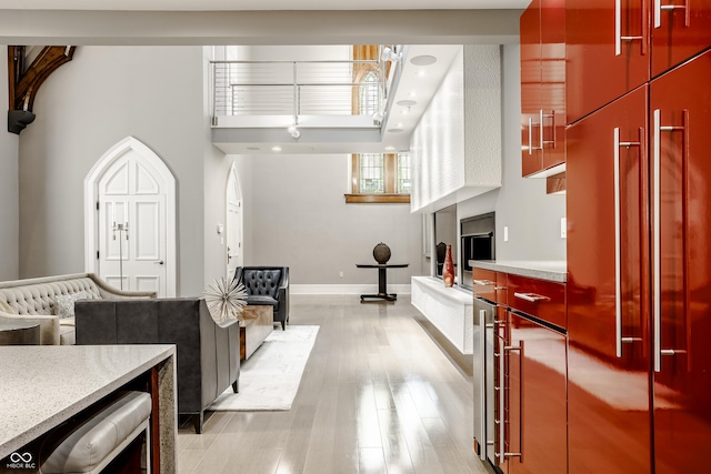 kitchen with paneled built in fridge and light hardwood / wood-style floors