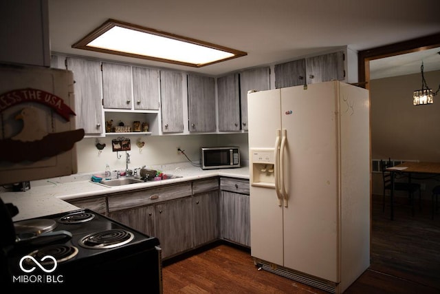 10050 E State Road 250, Crothersville, IN 47229 - kitchen featuring electric range, white fridge with ice dispenser, sink, dark hardwood / wood-style flooring, and pendant lighting