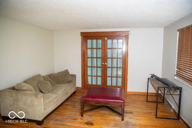 10050 E State Road 250, Crothersville, IN 47229 - living room with french doors, hardwood / wood-style floors, and a textured ceiling