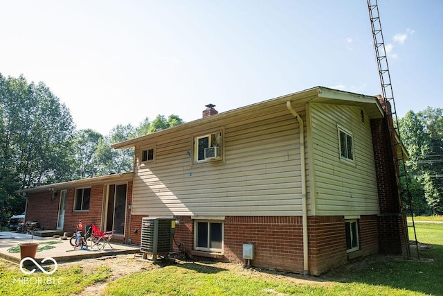 10050 E State Road 250, Crothersville, IN 47229 - back of property featuring a lawn, a patio area, and central AC unit