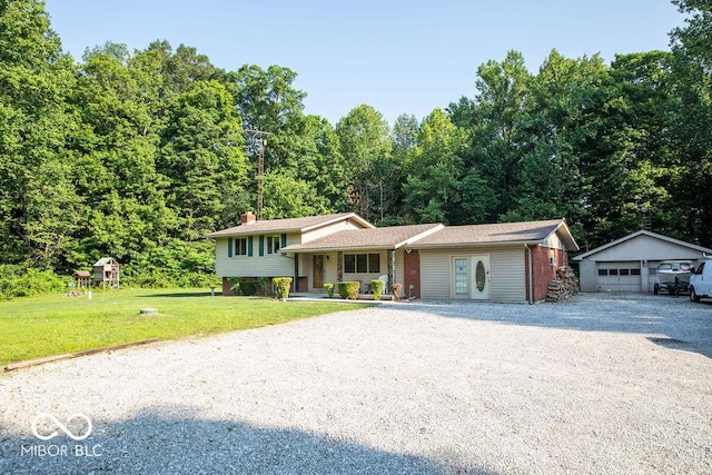 10050 E State Road 250, Crothersville, IN 47229 - view of front facade featuring an outbuilding, a front lawn, a porch, and a garage