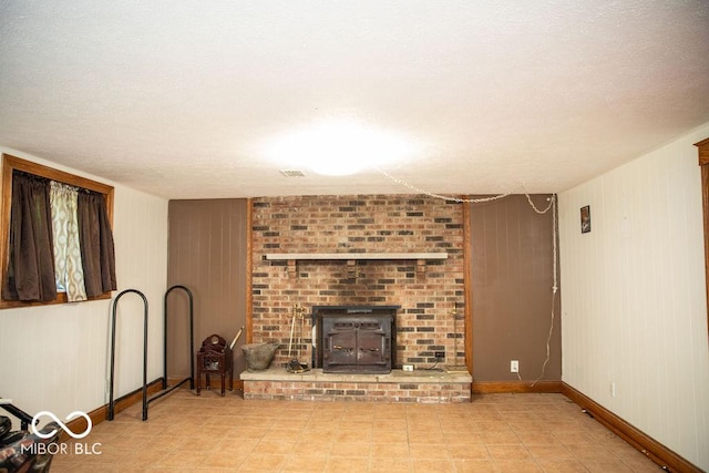 10050 E State Road 250, Crothersville, IN 47229 - living room featuring a textured ceiling, a wood stove, and wooden walls
