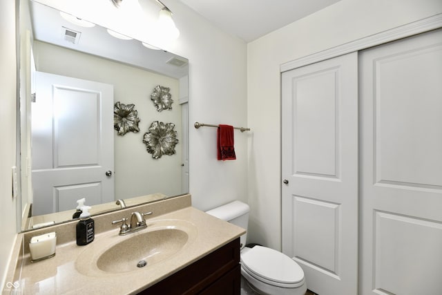 bathroom with toilet and vanity