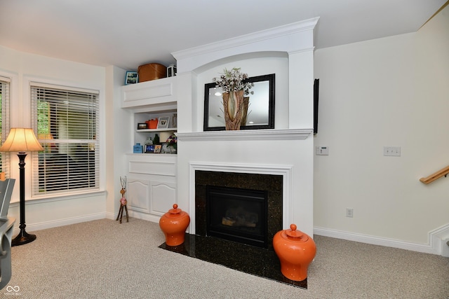 living room featuring built in shelves and carpet flooring