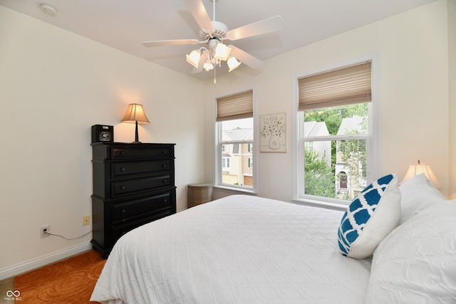 bedroom with ceiling fan and hardwood / wood-style floors