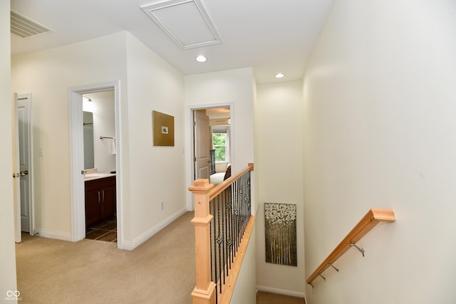 hallway featuring light carpet