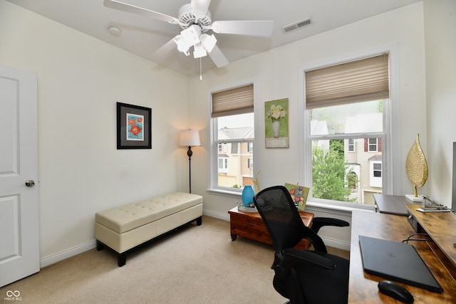 carpeted office featuring ceiling fan