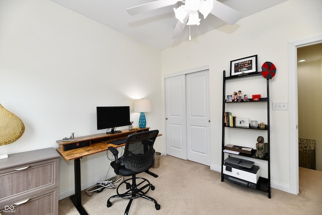 carpeted office space featuring ceiling fan