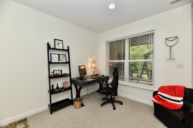 office area featuring light carpet