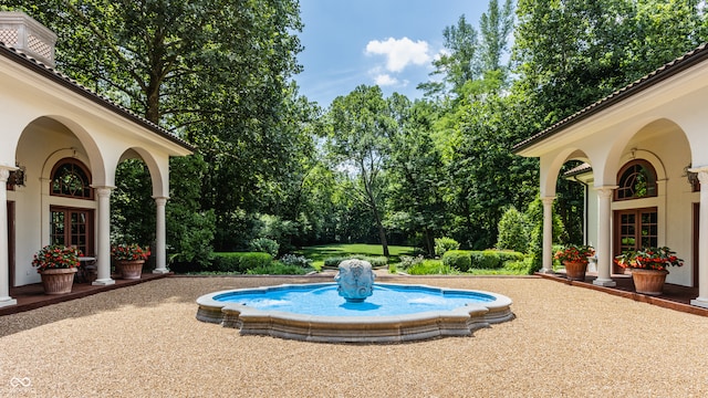 view of pool with french doors and a patio area