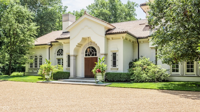 mediterranean / spanish-style home with a front lawn