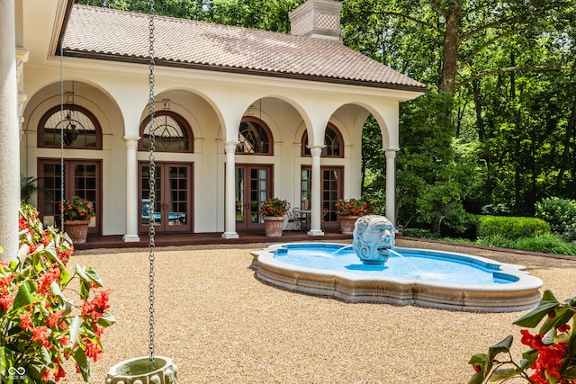 view of swimming pool with french doors and a patio area