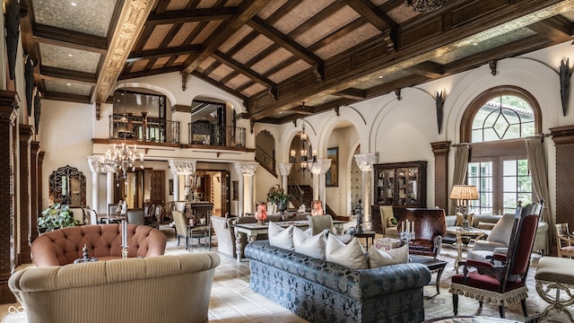 tiled living room with beam ceiling, an inviting chandelier, and high vaulted ceiling