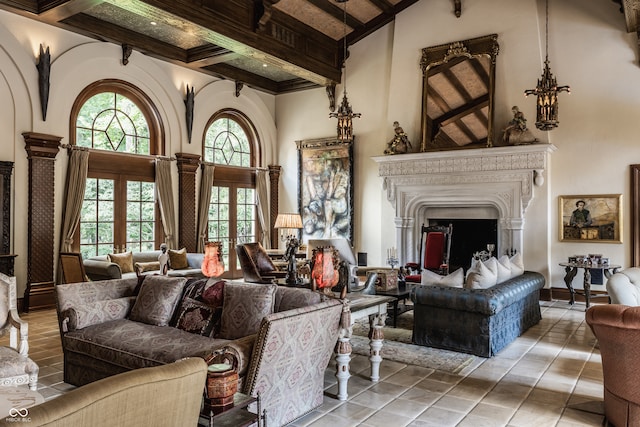 living room with a high ceiling, beam ceiling, and light tile patterned floors