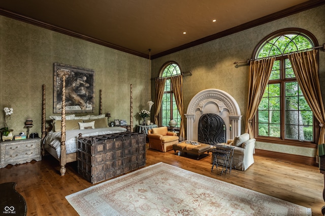 bedroom featuring wood-type flooring and crown molding