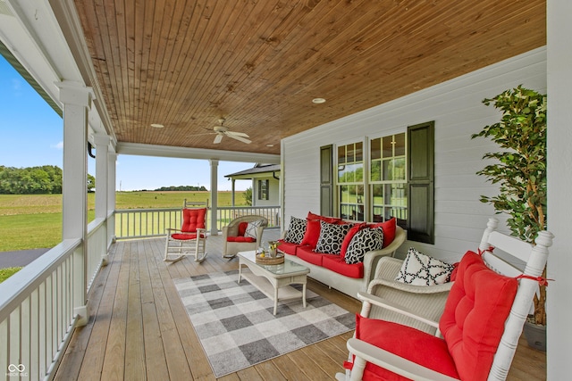 deck featuring a rural view, covered porch, and an outdoor hangout area