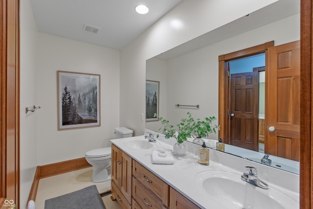 bathroom with vanity and toilet