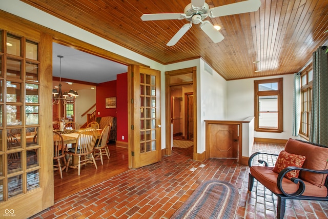 sitting room with a healthy amount of sunlight, crown molding, wooden ceiling, and ceiling fan with notable chandelier