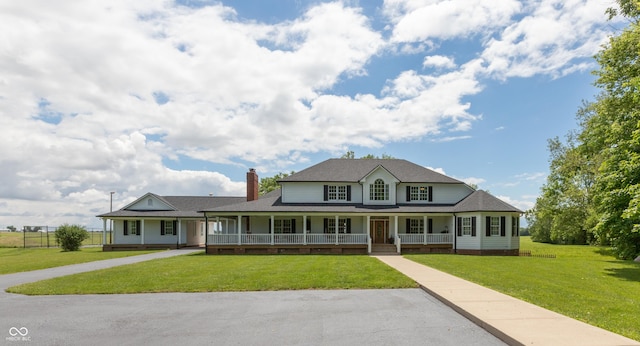 farmhouse with a front lawn and covered porch