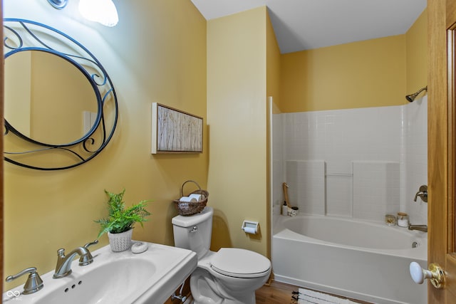 bathroom with hardwood / wood-style flooring, sink, and toilet