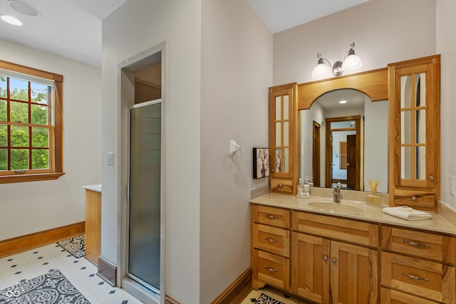 bathroom with a shower with door and vanity