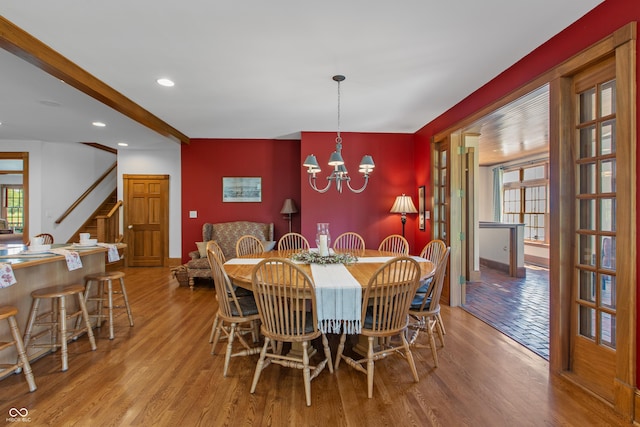 dining area featuring plenty of natural light, light hardwood / wood-style flooring, and an inviting chandelier