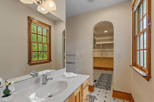 bathroom with radiator and vanity