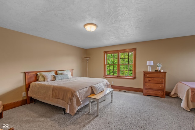 carpeted bedroom with a textured ceiling