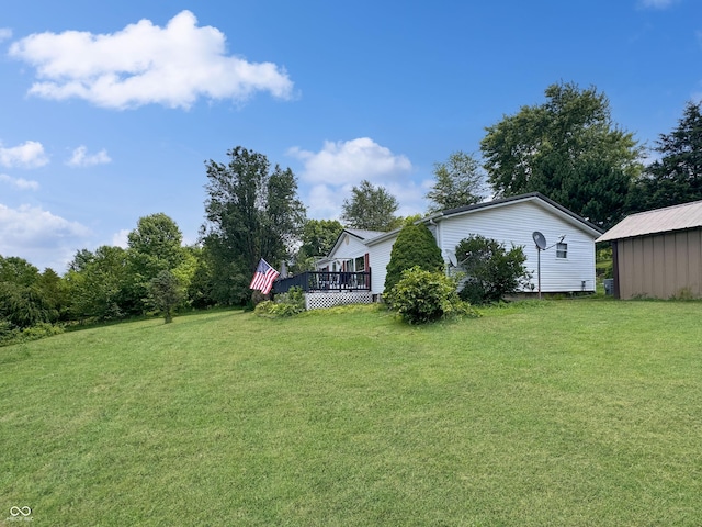 view of yard with a shed and a deck