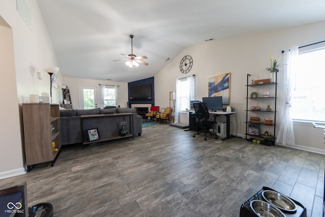 living room with ceiling fan, vaulted ceiling, and dark hardwood / wood-style flooring