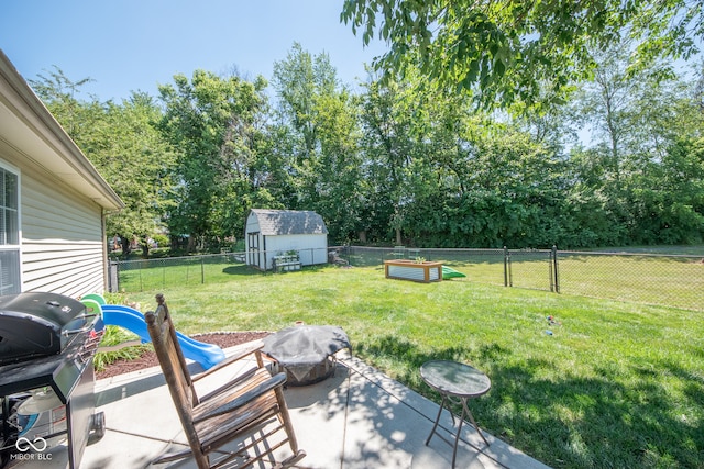 view of yard with a storage unit and a patio area