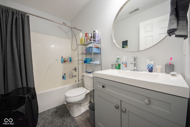 full bathroom featuring vanity, hardwood / wood-style floors, shower / bath combo with shower curtain, and toilet